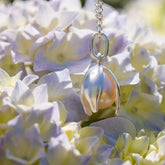 Pearl necklace hanging among hydrangea flowers